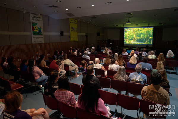 people in library watching eco film series