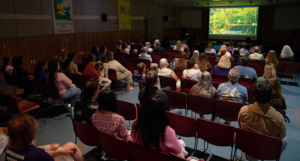 people in library watching eco film series