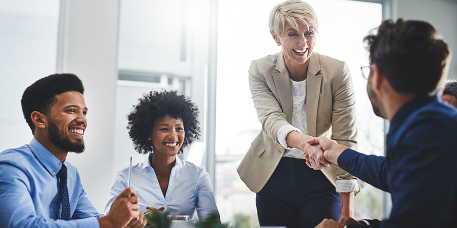group of people in office, shaking hands