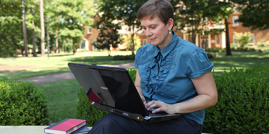 woman using laptop outside