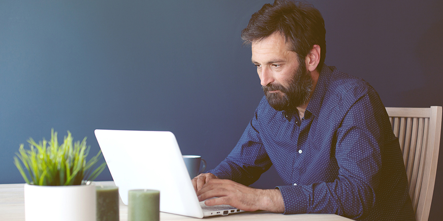 man using laptop at desk