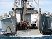 Military divers gather on the deck