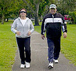 man and woman walking at the park