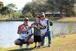 two men, a boy, and their fish