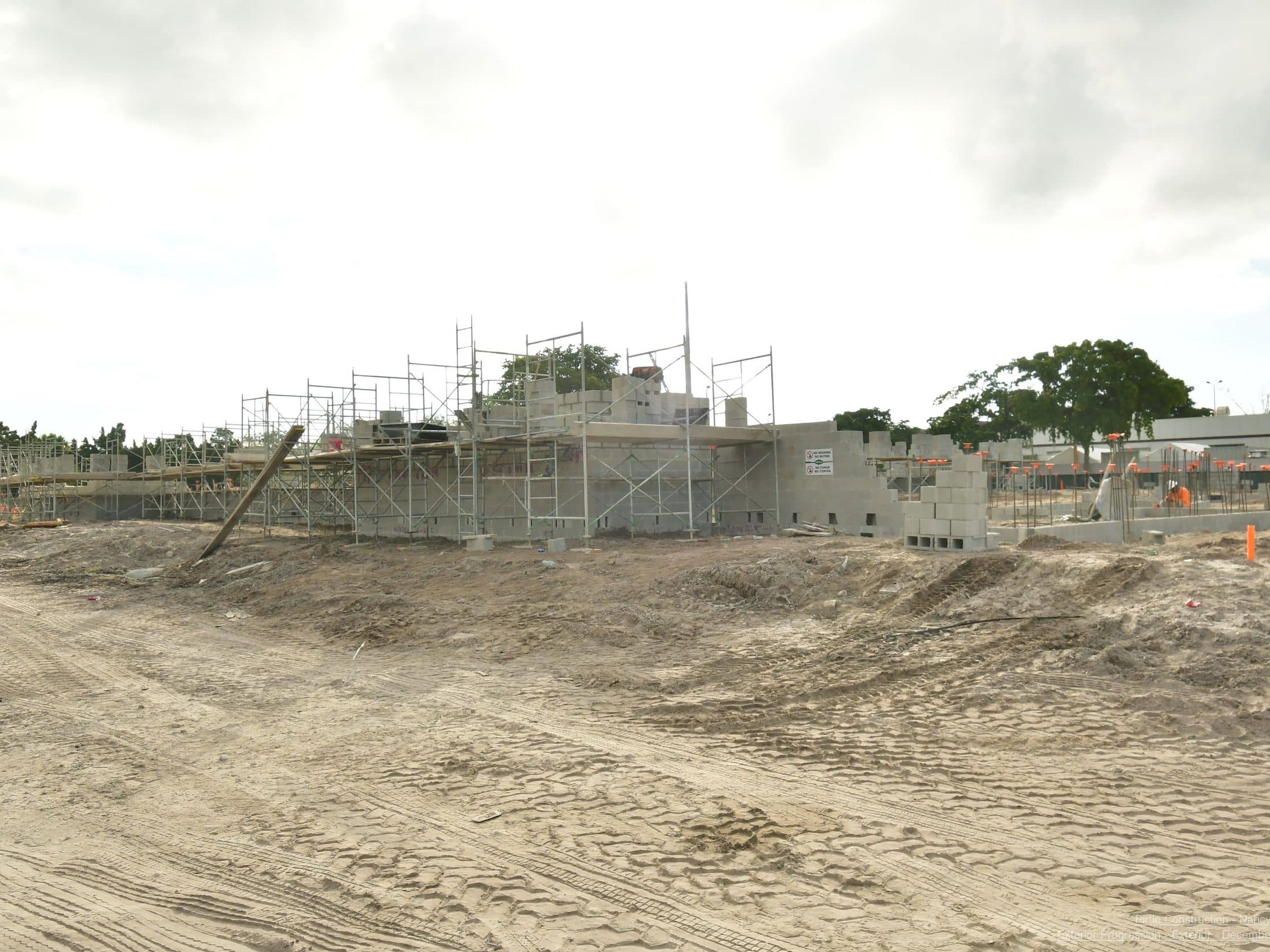 Ground photo of concrete block walls emerging from ground